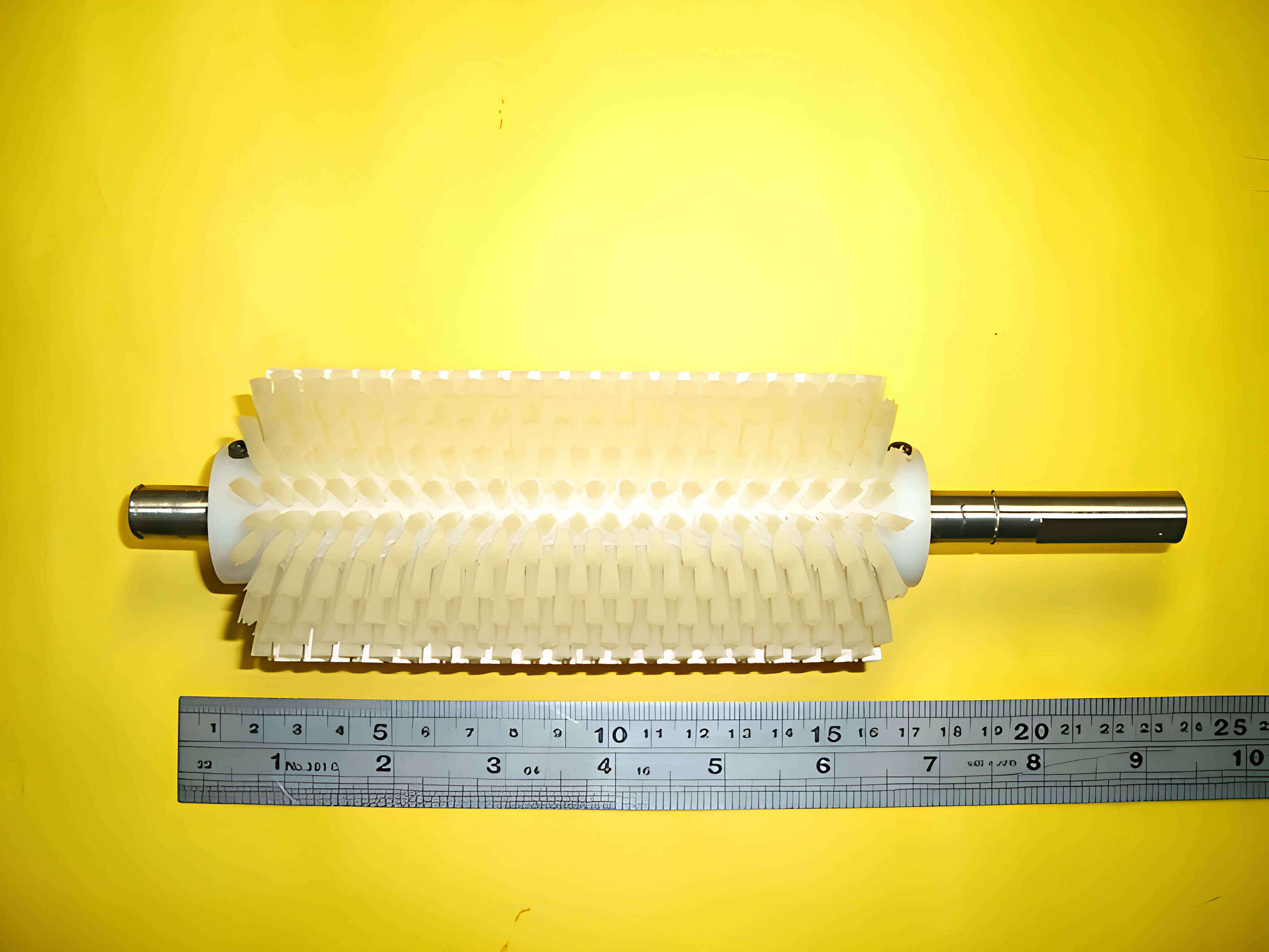 An actual YC Brushes roller brush with a steel ruler beside it for scale