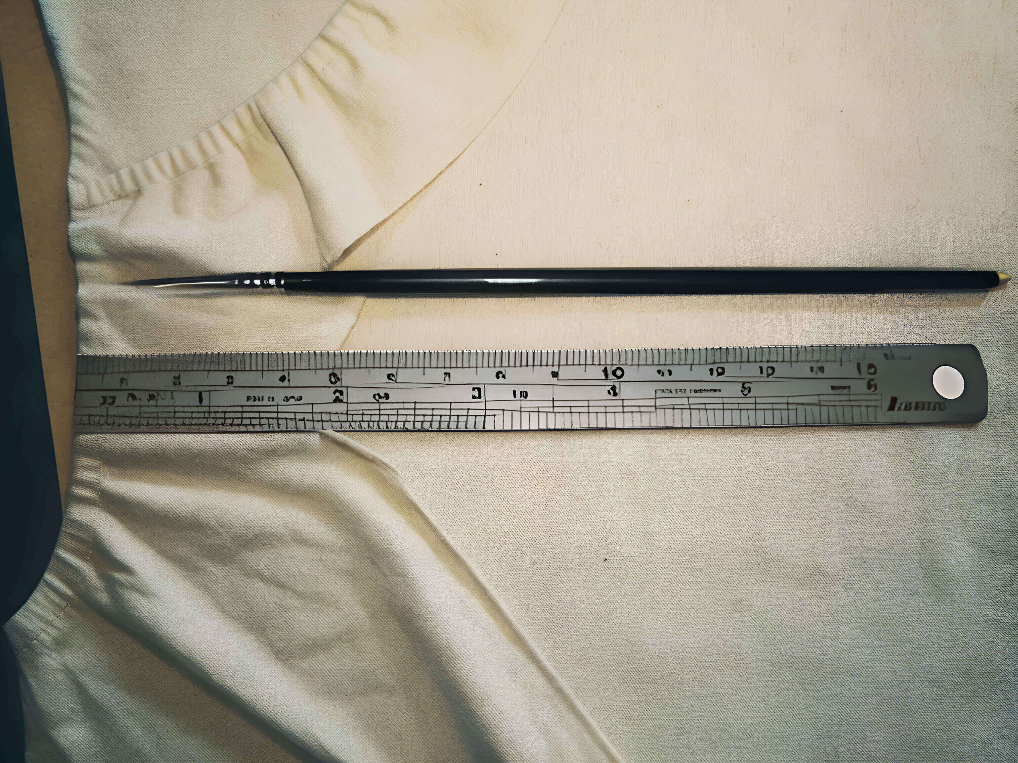 An actual YC Brushes fine touch-up brush with a steel ruler beside it to show the length